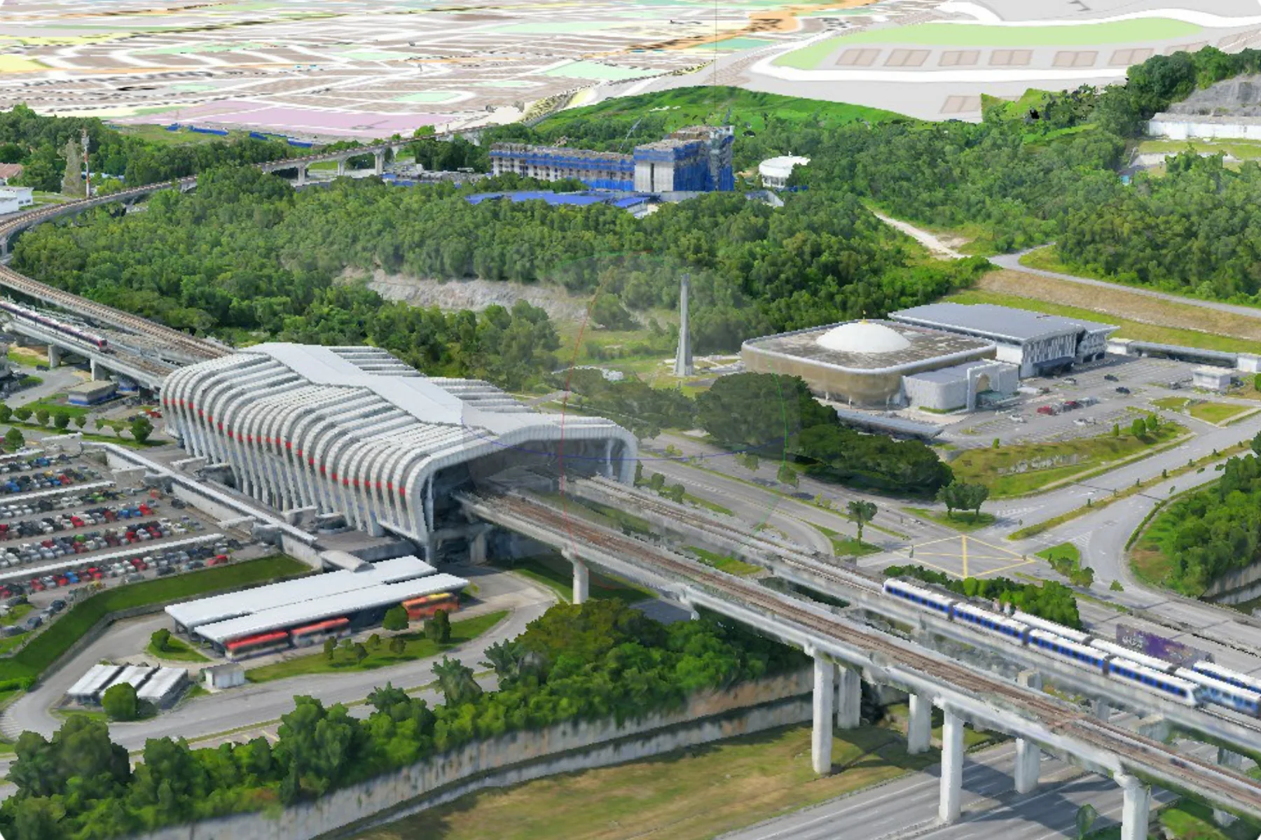 Textured 3D city model of a Malaysian transit interchange, with the modelled station roof, elevated rail viaduct and car parks below a flat cadastral map layer of the same district