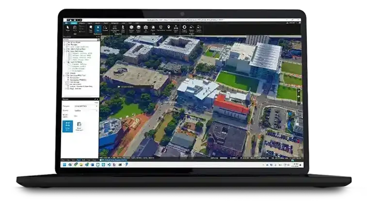 Skyline TerraExplorer open on a laptop, showing a textured 3D mesh of a city block