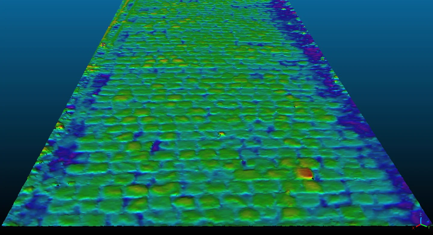 A colour-coded three-dimensional height map of a block-paved road surface, produced from XenomatiX road profile data